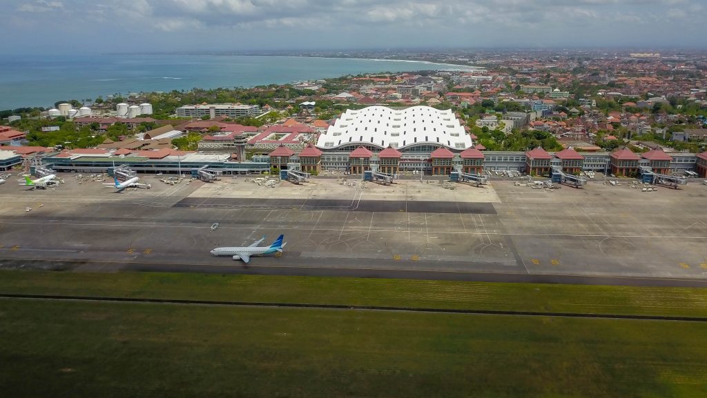 Aerial view of Ngurah Rai International Airport with runway and terminal buildings near Seminyak Bali